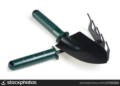 The garden tool a shovel, a rake. Isolated on a white background