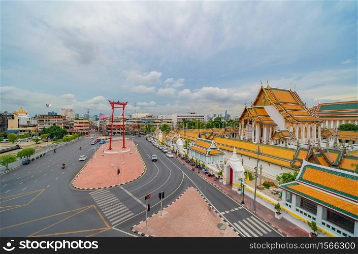 The Giant Swing or Sao Ching Cha monument with Wat Suthat temple at sunset in old town, Bangkok City, Thailand. Landmark tourist attraction. Thai architecture with travel trip concept.