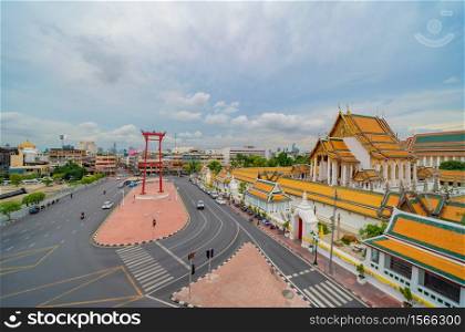 The Giant Swing or Sao Ching Cha monument with Wat Suthat temple at sunset in old town, Bangkok City, Thailand. Landmark tourist attraction. Thai architecture with travel trip concept.