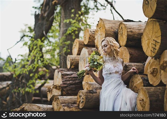 The girl among logs.. The girl in a dress in wood 3203.