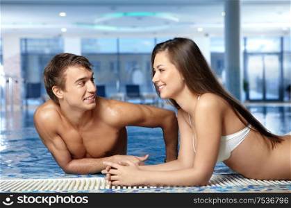 The girl and the guy communicate at pool