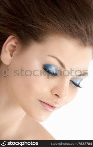 The girl blindly with a make-up in the blue tones, isolated