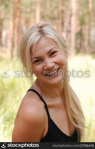 The girl blonde. In a black blouse and a happy smile on the person
