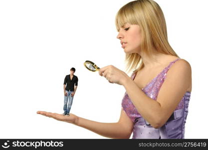 The girl considering the guy through a magnifier. The potential groom.It is isolated on a white background