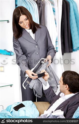 The girl consults on the guy about clothes choice