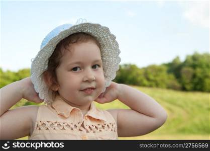 The girl in a hat. The Little girl on a background of the sky