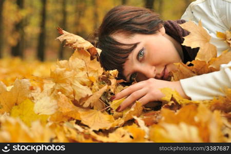 The girl in autumn leaves. The European appearance