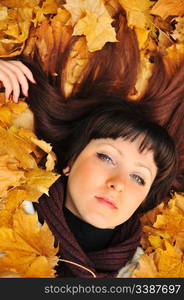 The girl in autumn leaves. The European appearance