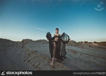 The girl in black linen among sandy dunes.. The girl in underwear among sand 3427.