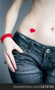 The girl in dark blue jeans with coral beads