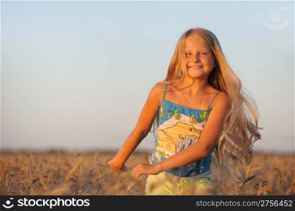The girl in filed wheats. Warm light sunset