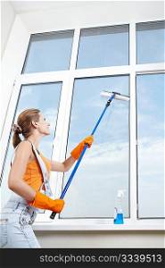 The girl in gloves washing windows mop for washing windows
