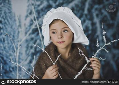 The girl in the white cap among the bushes in the frost.. The kid in the white cap in winter forest 4837.
