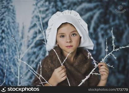 The girl in the white cap among the bushes in the frost.. The kid in the white cap in winter forest 4838.
