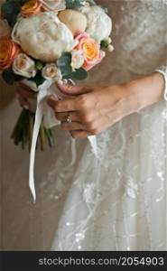 The girl is holding a beautiful bouquet in her hands.. A colorful bouquet in the hands of the bride 2777.