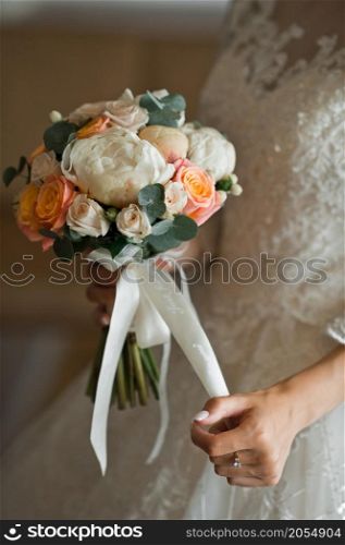 The girl is holding a beautiful bouquet in her hands.. A colorful bouquet in the hands of the bride 2778.