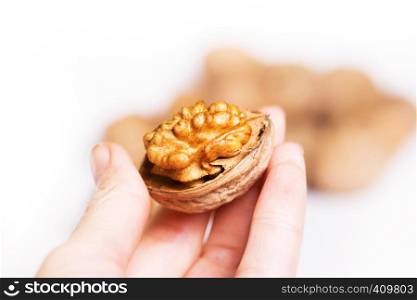 the girl is holding fresh useful walnuts