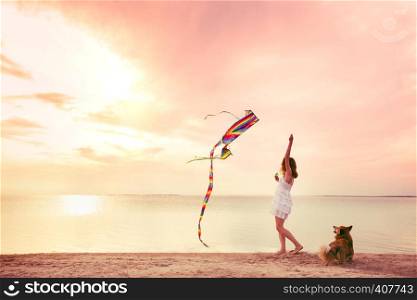 the girl launches a kite on the ocean shore during sunset. Florida