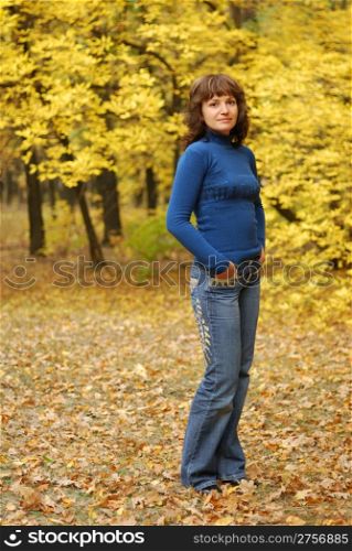 The girl on a background autumn forest. Age - 26 years