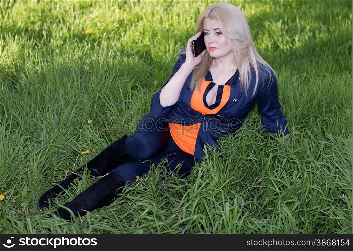 the girl on a lawn with phone, a green grass