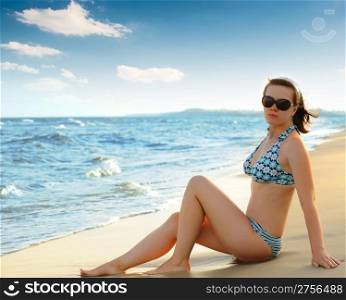 The girl on seacoast. The European appearance in sunglasses