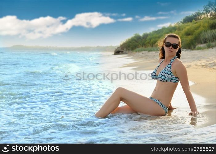 The girl on seacoast. The European appearance in sunglasses