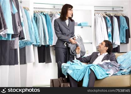 The girl shows to the man the price list in shop