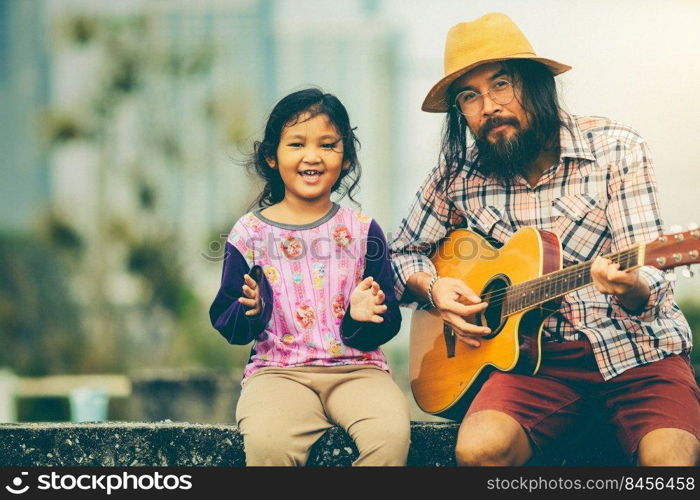 The girl sings with male musician playing guitar happy weekend