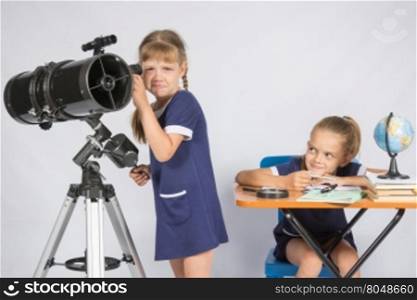 The girl was upset he did not see in the telescope, the other girl mocking her