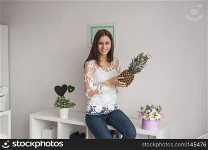 The girl with long hair holding a pineapple.. Girl with a pineapple in his hands 9033.