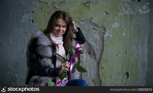The Girl With One Rose Is Sitting On A Chair. RAW HD Video