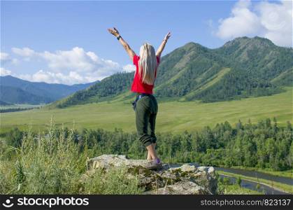 The girl with the raised hands in Mountains Altai Russia the top view