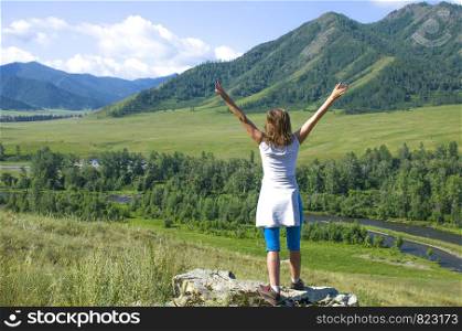 The girl with the raised hands in Mountains Altai Russia the top view