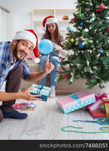 The girlfriend and boyfriend opening christmas gifts. Girlfriend and boyfriend opening christmas gifts