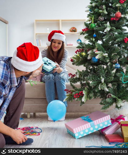 The girlfriend and boyfriend opening christmas gifts. Girlfriend and boyfriend opening christmas gifts