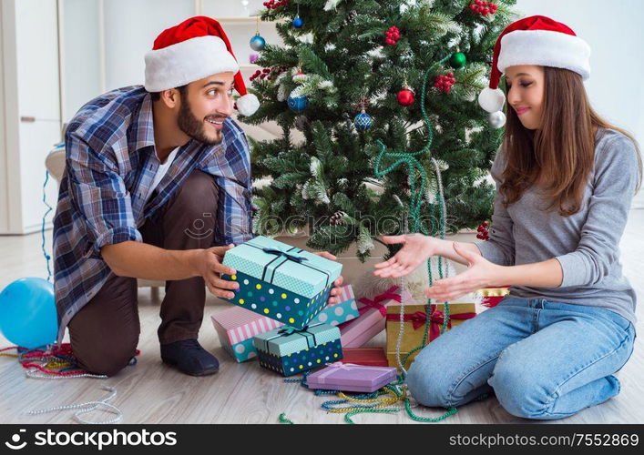 The girlfriend and boyfriend opening christmas gifts. Girlfriend and boyfriend opening christmas gifts