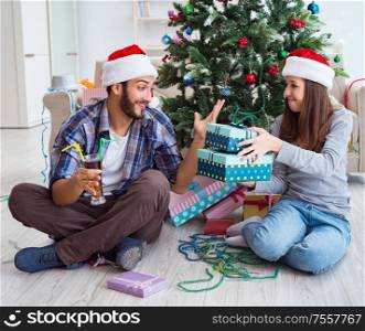 The girlfriend and boyfriend opening christmas gifts. Girlfriend and boyfriend opening christmas gifts