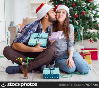 The girlfriend and boyfriend opening christmas gifts. Girlfriend and boyfriend opening christmas gifts