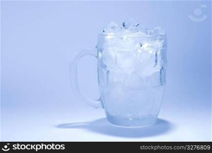 the glass full of ice cube with blue background
