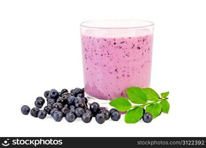 The glass of milkshake, berries and green sprig of blueberries isolated on white background