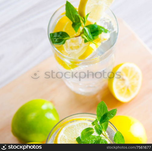 The glasss of mojito with lemon and drinking straw. Glasss of mojito with lemon and drinking straw