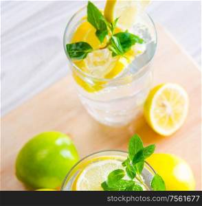The glasss of mojito with lemon and drinking straw. Glasss of mojito with lemon and drinking straw