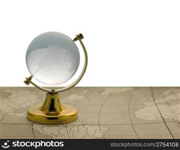 The globe. The glass globe on the yellow support, isolated on a white background