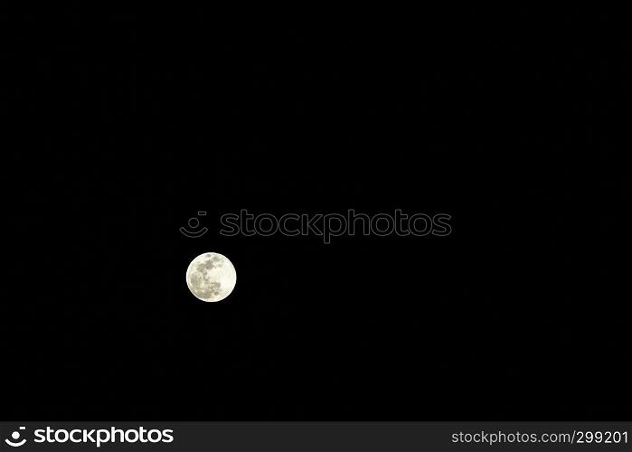 The gold super full moon isolated on black on febraury 19, 2019