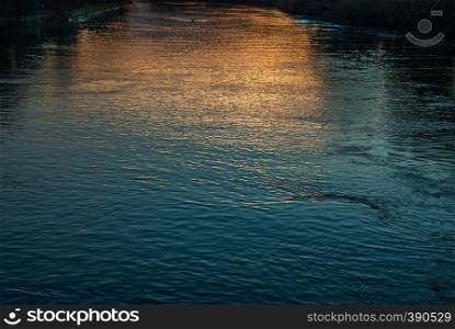 The golden and blue light reflected in the Thames at sunset