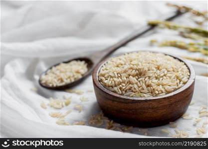 The grain in a wooden cup rests on a white cloth, healthy food and diet concept.