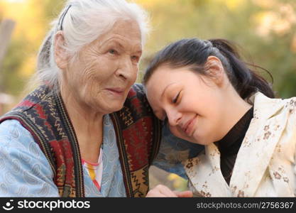 The grandmother with the grand daughter. A photo on outdoors
