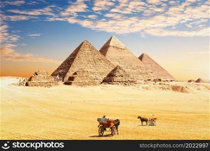 The Great Pyramids of Egypt and traditional desert carriages, Cairo, Giza.. The Great Pyramids of Egypt and traditional desert carriages, Cairo, Giza