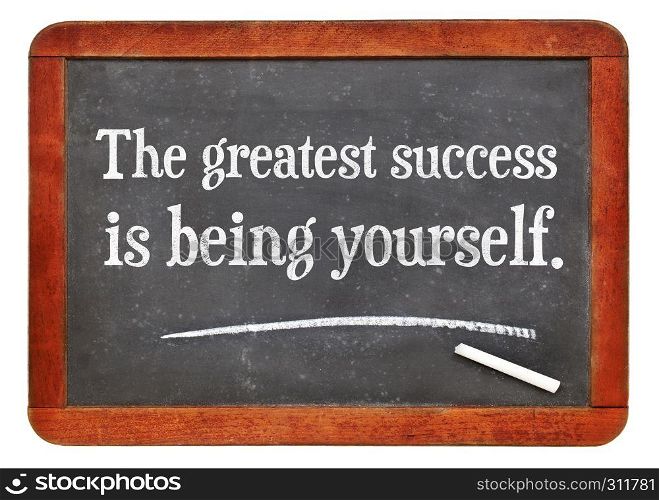 the greatest success is being yourself - white chalk text on a vintage slate blackboard. blackboard