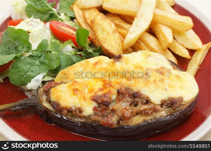 "The Greek dish of aubergines stuffed with minced beef, onion and tomatoes, topped with bechamel sauce and cheese, served taverna-style with a salad of rocket, lettuca and tomato, and french fried potato chips. The dish is called melitzanes papoutsakia, or "aubergine little-shoes""